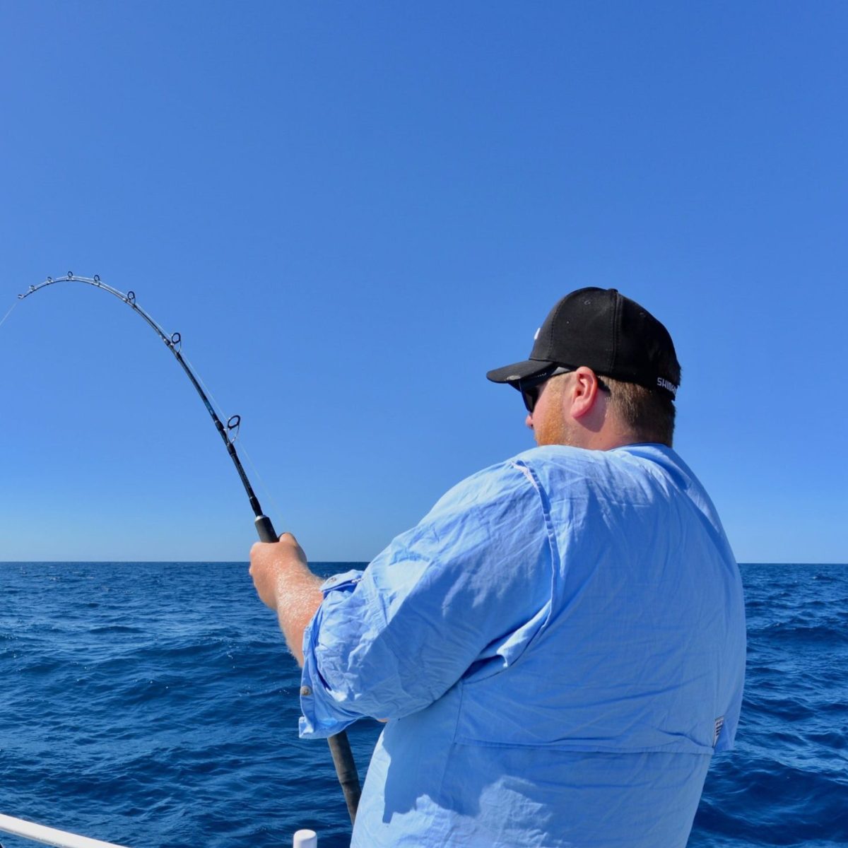 a man fishing with airlie beach fishing charters in airlie beach, queensland